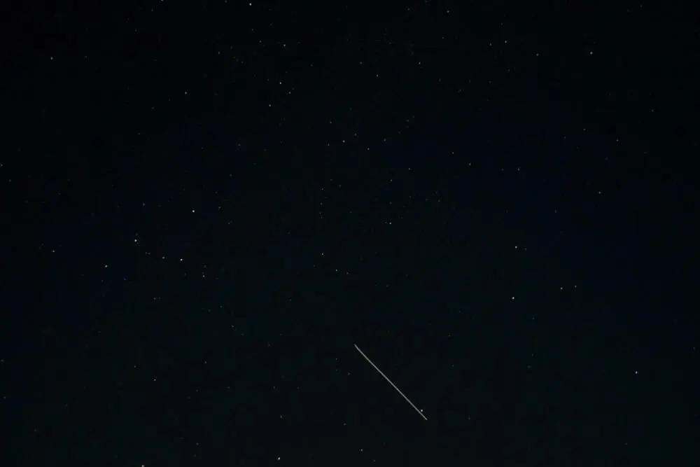 an airplane flying in the sky at night