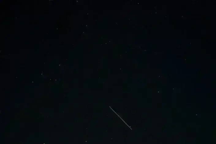 an airplane flying in the sky at night
